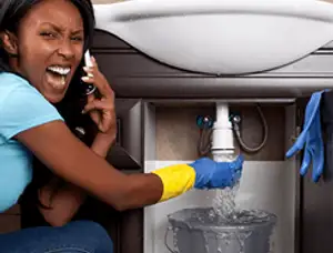 Emergency plumbing repair for a leaking sink drain under a bathroom vanity in Highland Park, IL