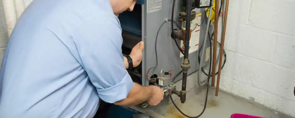 Furnace repair technician inspecting and servicing a home heating system in Highland Park, IL