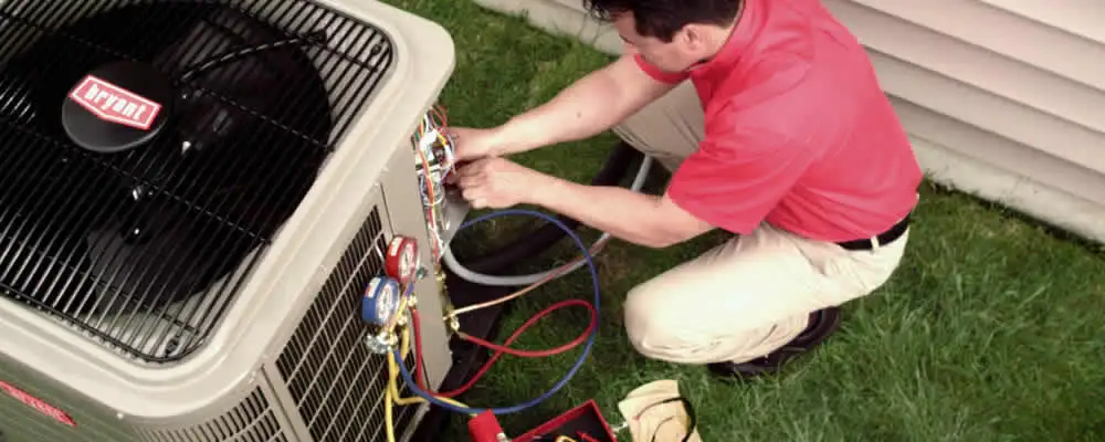 HVAC technician servicing an outdoor air conditioner unit in Highland Park, IL