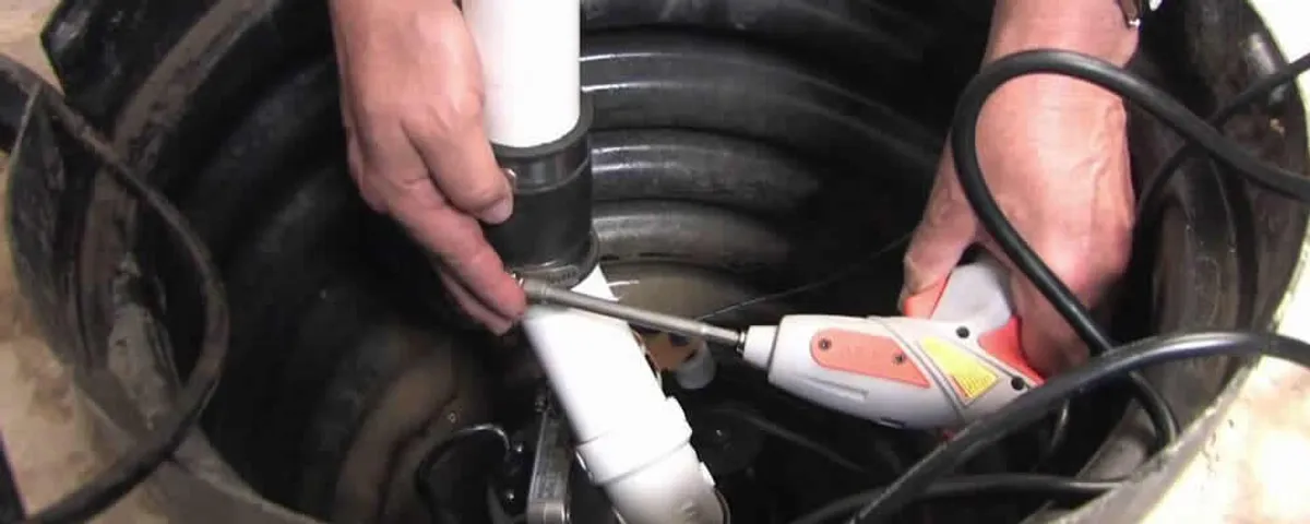 Sump pump installation technician connecting PVC discharge piping in Highland Park, IL